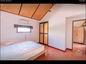 a bedroom with a white bed and a window at Villa “Mango” in Villa Vista, Hua Hin in Khao Tao