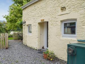 a brick building with a door and a window at Yr Ysgubor - U45300 in Carmarthen