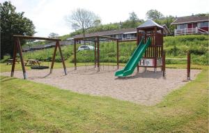 a playground with a slide in a park at Amazing Home In Aabenraa With Kitchen in Løjt