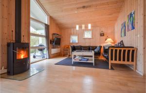 ØrbyにあるAwesome Home In Knebel With 4 Bedrooms And Saunaのリビングルーム(暖炉、ソファ付)