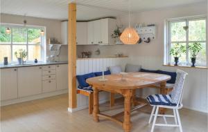 cocina y comedor con mesa de madera y sillas en Cozy Home In Ebeltoft With Wifi, en Ebeltoft