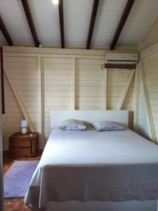 a bedroom with a large white bed in a room at Mango Villa in Les Abymes