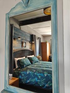 a mirror reflection of a bed in a bedroom at Dibney Rig in Killyleagh
