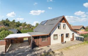 a house with a solar roof on top of it at Beautiful Home In Nrre Nebel With Kitchen in Nørre Nebel