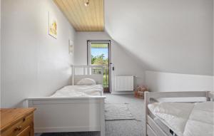 a bedroom with two bunk beds and a window at Beautiful Home In Nrre Nebel With Kitchen in Nørre Nebel
