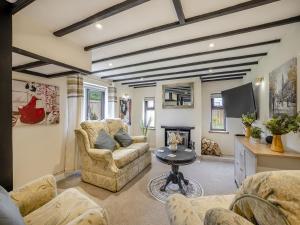 a living room with a couch and a fireplace at Huntspill Cottage in Holbeach