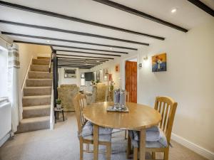 a dining room with a table and chairs at Huntspill Cottage in Holbeach