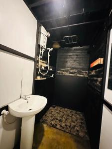 a small bathroom with a sink and a toilet at hornbill river camp udawalwa in Udawalawe