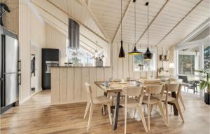 a kitchen and dining room with a table and chairs at Three-Bedroom Holiday Home In Knebel in Knebel