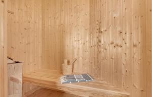 a wooden interior of a sauna with a book at Three-Bedroom Holiday Home In Knebel in Knebel +16 photos