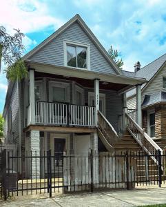 a house with a deck and a porch at Cozy & Spacious in Irving Park in Chicago