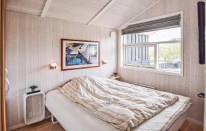 um quarto com uma cama e uma janela em Nice Home In Juelsminde With Sauna em Sønderby
