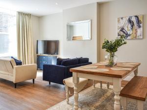 a living room with a table and a couch at South Street House in Cockermouth