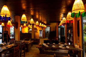 a restaurant with tables and chairs and chandeliers at Black Ship Sapa in Sapa