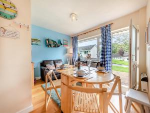 a dining room and living room with a table and chairs at Awesome Cottage In Cilau Aeron, Near Lampeter With 2 Bedrooms And Wifi in Ciliau-Aeron