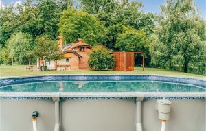 a swimming pool in the back yard of a house at Awesome Home In Rokovci With Outdoor Swimming Pool 