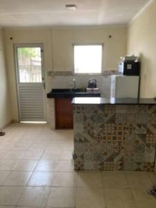 a kitchen with a counter top and a refrigerator at Casa centrica! in Artigas