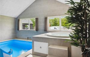 a swimming pool with a tub in a house at Aqua 221 in Krakow am See
