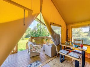 a room with a table and chairs in a tiny house at The Owls Hollow - Uk45297 in Bishop Thornton