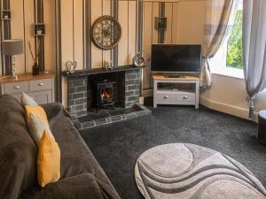 a living room with a couch and a fireplace at The Garden House in Folkestone