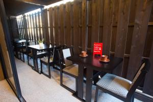a row of tables and chairs in a restaurant at Ebisu Ryokan in Kyoto
