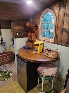 a kitchen with a table and a chair in a room at Hobbit Haven in Santa Barbara