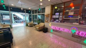 a lobby with a bar with a rainbow sign on it at Alongkorn hotel by SB in Samut Songkhram