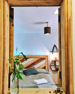 a bedroom with a bed and a potted plant at Casa Boutique 55 in San Cristóbal de Las Casas