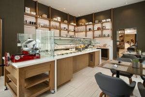 a restaurant with a counter and chairs and a table at AC Hotel by Marriott Oakland Downtown in Oakland