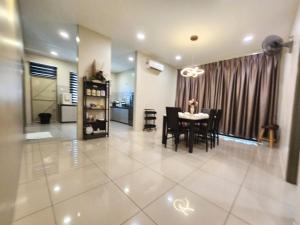 a dining room and living room with a table and chairs at Relax Inn 92 Alor Setar 旅安居 in Alor Setar