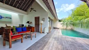 a living room with a pool and a house at The Decks Bali in Legian