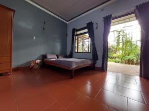 a living room with a bed and a window at The Lazy Farm-Garden Central Room in Mewal +25 photos
