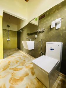 a bathroom with a toilet and a sink at La Seran Eco Resort in Bandarawela +60 photos
