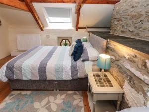 a small bedroom with a bed and a table at Ty Llwyd in Eglwyswrw