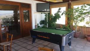 a pool table in a room with a tv at Pissouriana hotel Apartments in Pissouri