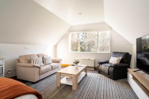 a living room with a couch and a table at Country Apartment in Paraparaumu