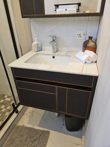 a bathroom vanity with a sink and a mirror at Villa Serene in Lusaka