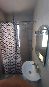 a bathroom with a sink and a shower curtain at Pine Apartment 2 plus 1 in Golem +46 photos