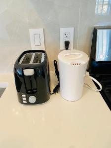 a black toaster sitting on a counter next to a cup at Home sweet home in Richmond