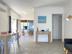 a living room and dining room with a table and chairs at Inverloch Sands in Inverloch