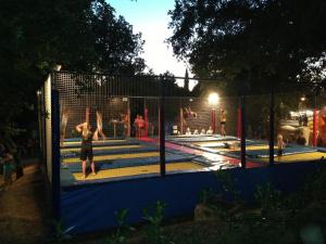 a group of people playing in a trampoline at Easyatent Mobile home Lanterna in Poreč