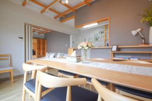 a dining room with a long table and chairs at Comfy Stay TDS in Nara