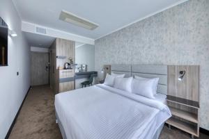 Katil atau katil-katil dalam bilik di Expocore Hotel