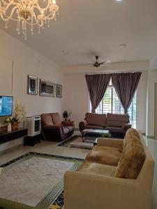 a living room with a couch and a tv at Dhana Palace Homestay Gelang Patah in Johor Bahru