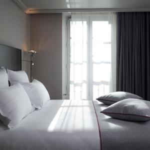 Voodi või voodid majutusasutuse Hotel Saint Dominique toas
