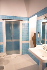 a bathroom with a shower and a toilet and a sink at Relais Santa Caterina Hotel in Viterbo