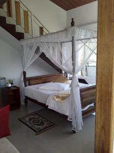 a bedroom with a large bed with a canopy at Tea Hills Bungalow in Hatton