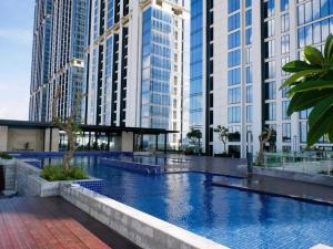 a large swimming pool in a city with tall buildings at Amazing view 2 bedrooms new apartment in Batam Center