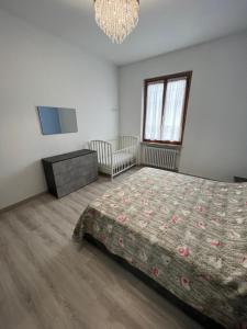 a bedroom with a bed and a chandelier at Casa Gabriel in Anghiari +7 photos