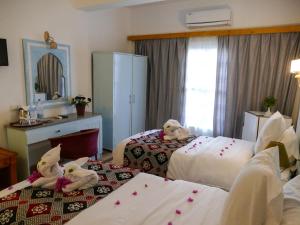 Postel nebo postele na pokoji v ubytování El Gezira Hotel